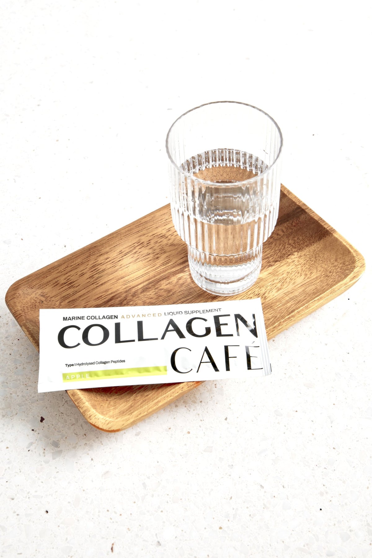 Collagen Café Marine Collagen sachet with a glass of water